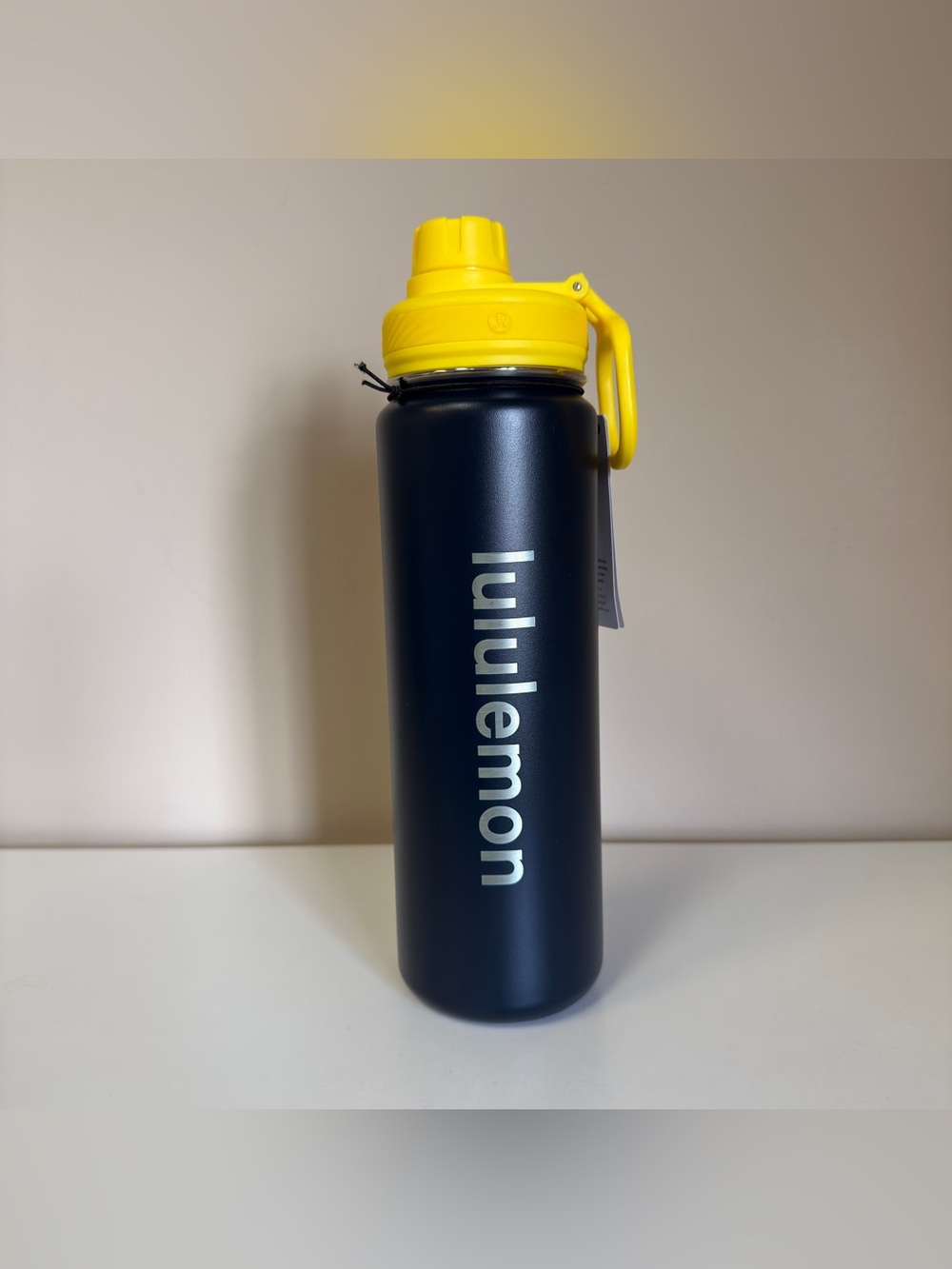 lululemon navy water bottle with yellow handle lid